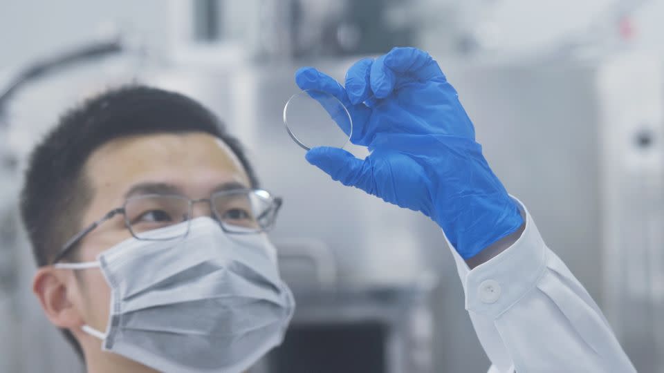 A researcher at China's Zhejiang University Hangzhou International Science and Innovation Center looks at gallium oxide wafers on May 30, 2022. - CFOTO/Future Publishing/Getty Images