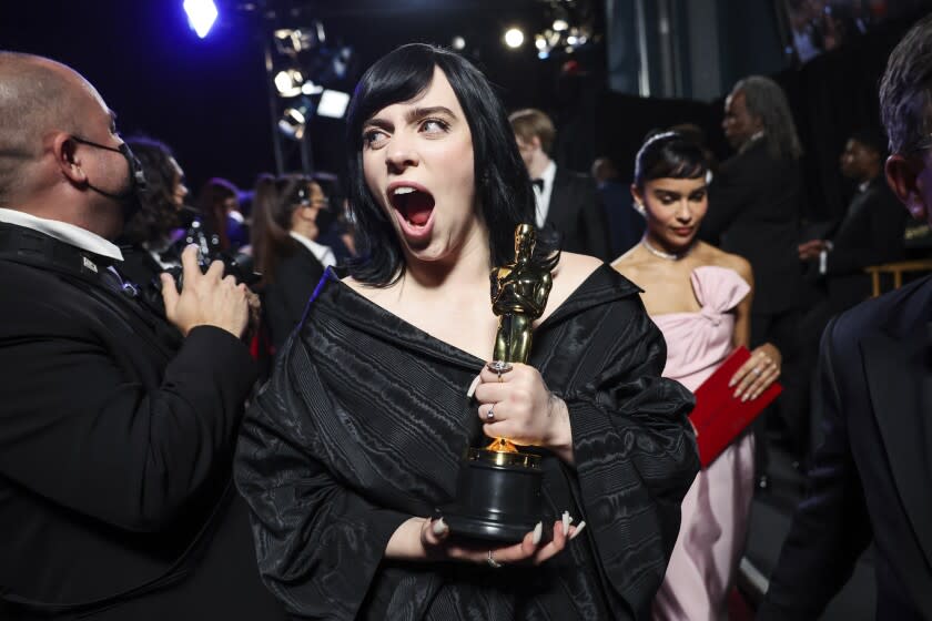 HOLLYWOOD, CA - March 27, 2022: Billie Eilish cheers after winning Oscar for best original song "No Time To Die" during the show at the 94th Academy Awards at the Dolby Theatre at Ovation Hollywood on Sunday, March 27, 2022. (Robert Gauthier / Los Angeles Times)