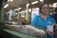 An employee works on her station at a factory of cigarette-maker Brascuba in Havana May 11, 2015. REUTERS/Alexandre Meneghini