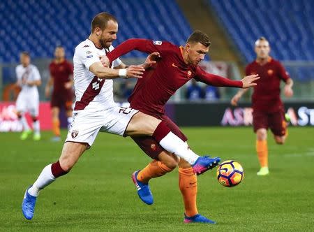 Football Soccer - AS Roma v Torino - Italian Serie A - Olympic stadium, Rome, Italy - 19/02/17 - AS Roma's Edin Dzeko in action against Torino's Lorenzo De Silvestri. REUTERS/Tony Gentile