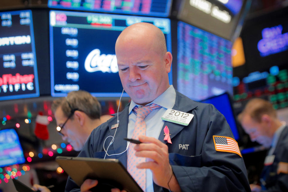 Traders work on the floor at the New York Stock Exchange