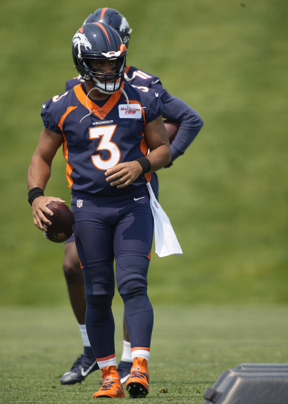 Denver Broncos quarterback Russell Wilson takes part in drills during the NFL team's practice at the Broncos' headquarters Monday, June 13, 2022, in Centennial, Colo. (AP Photo/David Zalubowski)