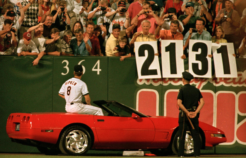 Cal Ripken Jr., sitting on the back of a sportscar, receives a standing ovation from the crowd at Camden Yards. (Roberto Borea/AP)