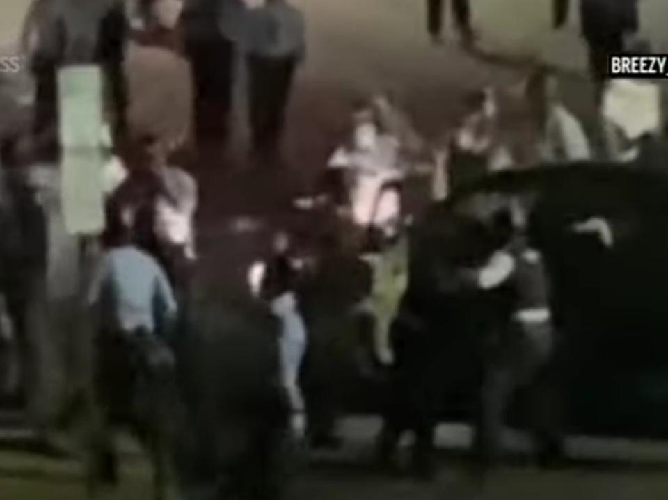 A screengrab of video showing officers and protesters surround Rickia Young’s vehicle (AP/CBSPHilly)