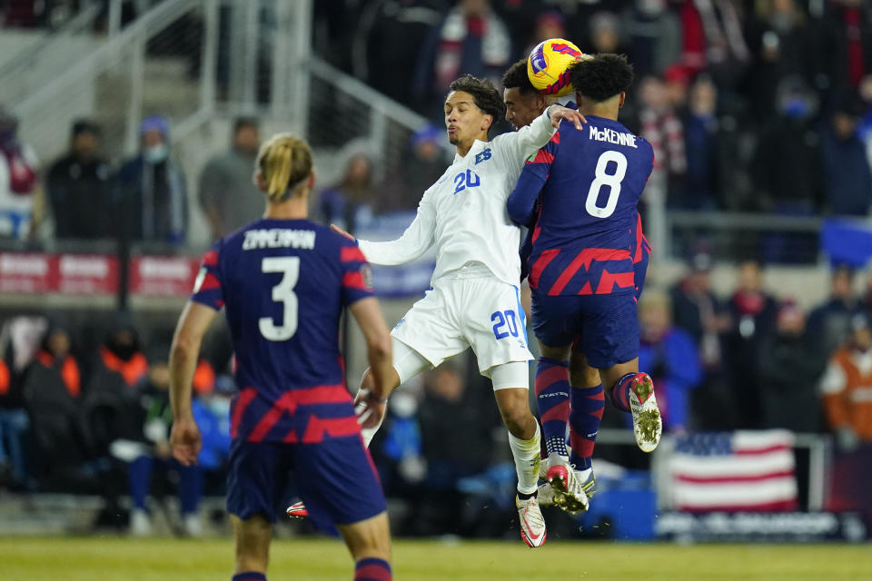 El Salvador's Enrico Duenas (20) goes up for the ball against United States' Weston McKennie (8) and Tyler Adams, back, during the first half of a FIFA World Cup qualifying soccer match, Thursday, Jan. 27, 2022, in Columbus, Ohio. Walker Zimmerman (3) looks on. (AP Photo/Julio Cortez)