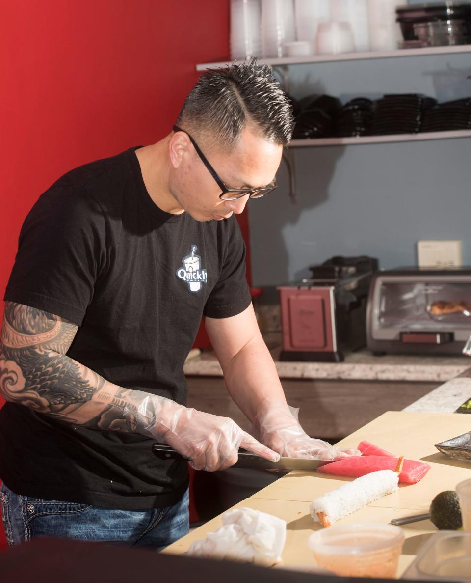 Tung Tran prepares a sushi order at the new Quickly restaurant on Monday, March 18, 2019.