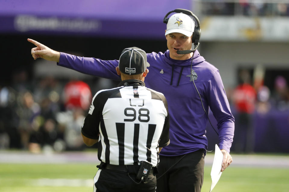 Minnesota Vikings head coach Kevin O'Connell talks with line judge Greg Bradley (98) during the first half of an NFL football game against the Chicago Bears, Sunday, Oct. 9, 2022, in Minneapolis. (AP Photo/Bruce Kluckhohn)