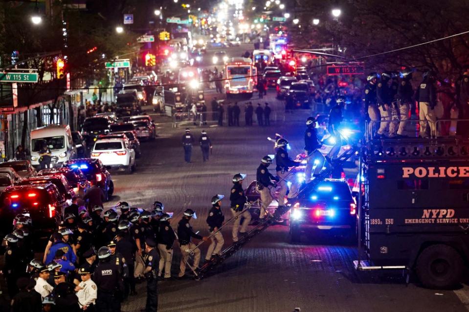 NYPD personnel use a vehicle outfitted with a latter to evict students from Hamilton Hall on the campus of Columbia University on Tuesday. REUTERS