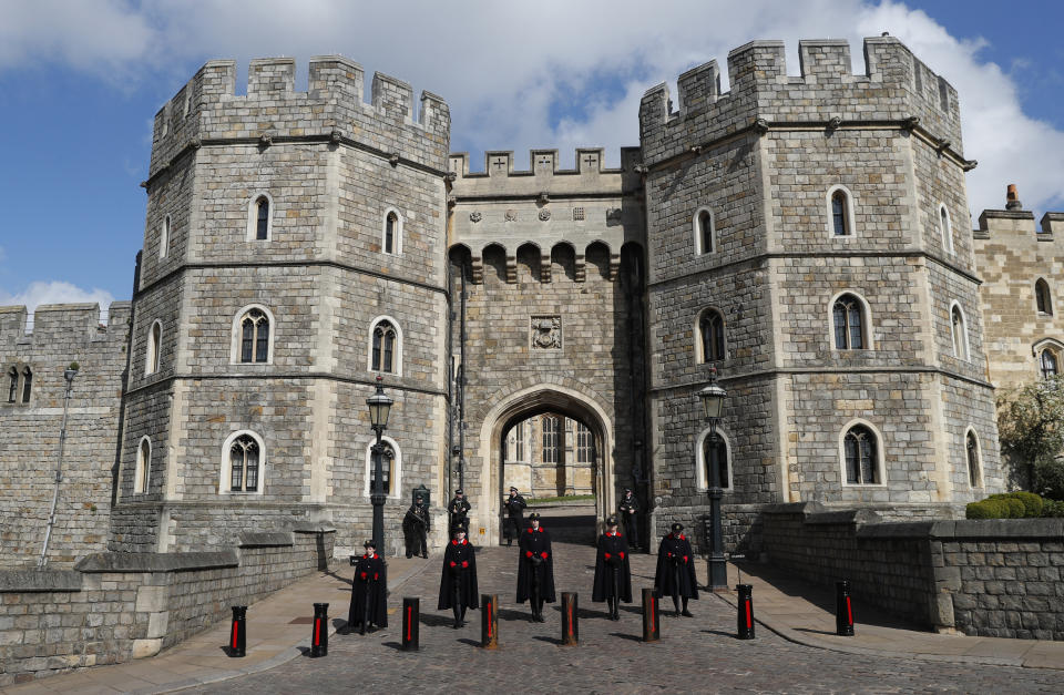 Wardens and armed police guard the Henry VIII gate in Windsor, England, Friday, April 16, 2021. Prince Philip husband of Britain's Queen Elizabeth II died April 9, aged 99, his funeral will take place Saturday at Windsor Castle in St George's Chapel. (AP Photo/Alastair Grant)