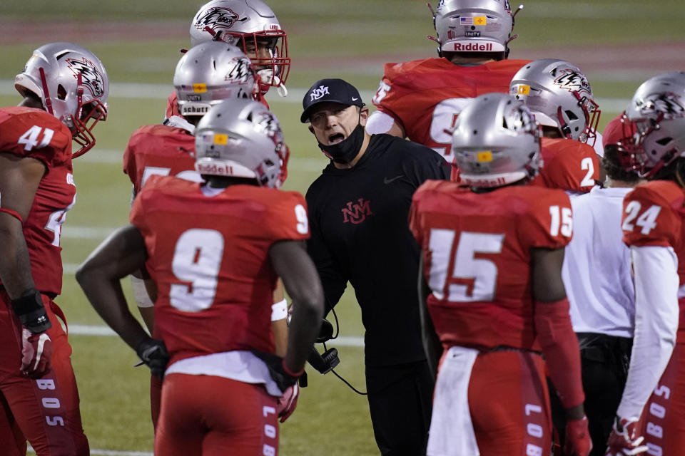 FILE - In this Saturday, Nov. 14, 2020, file photo, New Mexico head coach Danny Gonzales speaks with players during the second half of an NCAA college football game against Nevada, in Las Vegas. Coronavirus restrictions in New Mexico make it impossible for the schools there to play their seasons. New Mexico's football team was the first to temporarily relocate, moving to the Las Vegas area to practice and play. (AP Photo/John Locher, File)