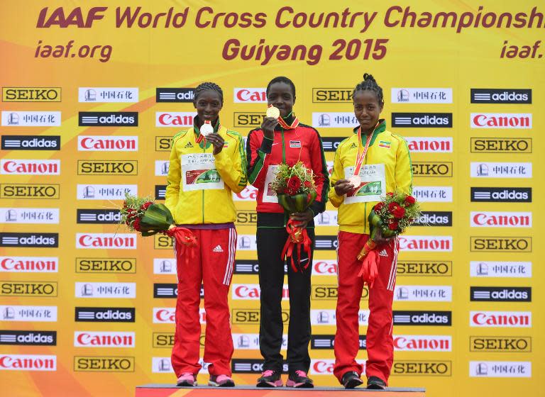 Agnes Tirop (centre) became the youngest senior women's winner for 30 years of the World Cross Country championships