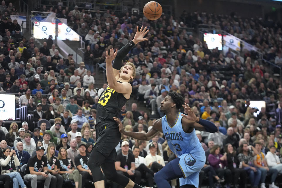 Utah Jazz forward Lauri Markkanen (23) shoots as Memphis Grizzlies forward Jaren Jackson Jr. (13) defends during the first half of an NBA basketball game Wednesday, Nov. 1, 2023, in Salt Lake City. (AP Photo/Rick Bowmer)