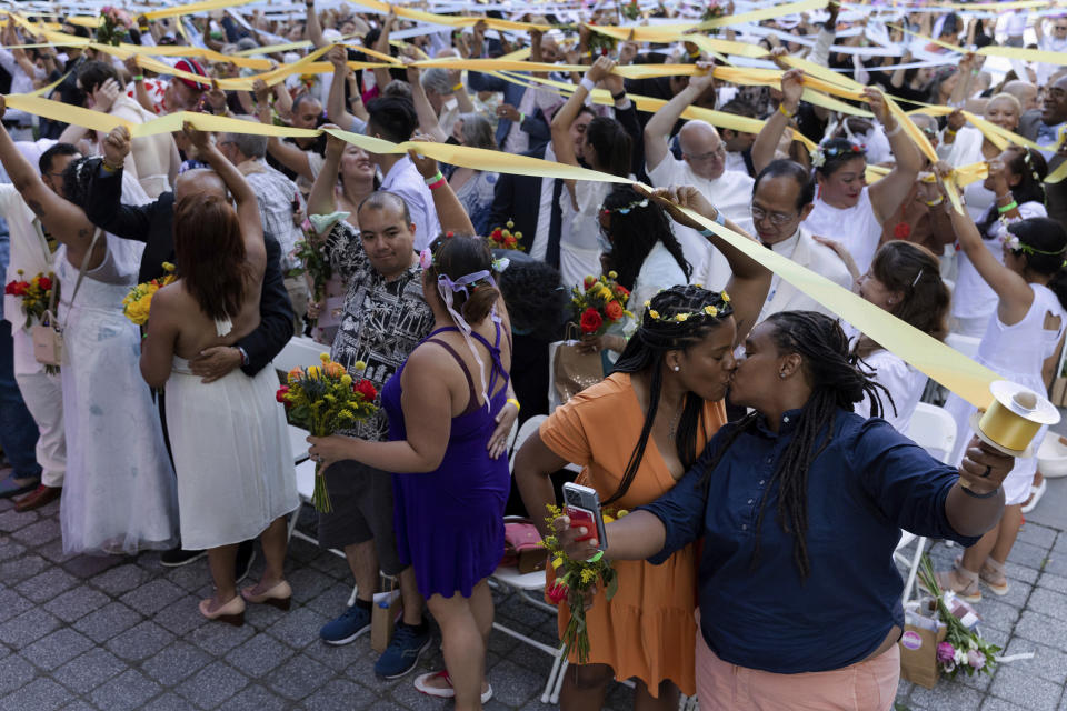 FILE - Couples, whose weddings were cancelled or curtailed during the COVID-19 pandemic, participate in a symbolic multicultural ceremony at Damrosch Park, Sunday, July 10, 2022, in New York. (AP Photo/Julia Nikhinson, File)