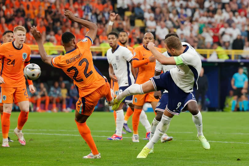 Denzel Dumfries fouls Harry Kane