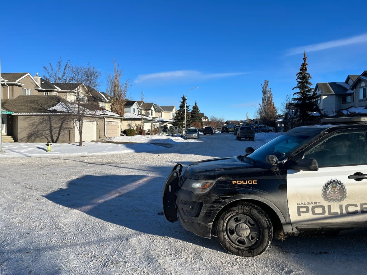 A Calgary police vehicle is parked near the location of a shooting in Calgary's Douglasdale neighbourhood in the city's southeast on Thursday, Dec. 15, 2022. (Dave Gilson/CBC - image credit)