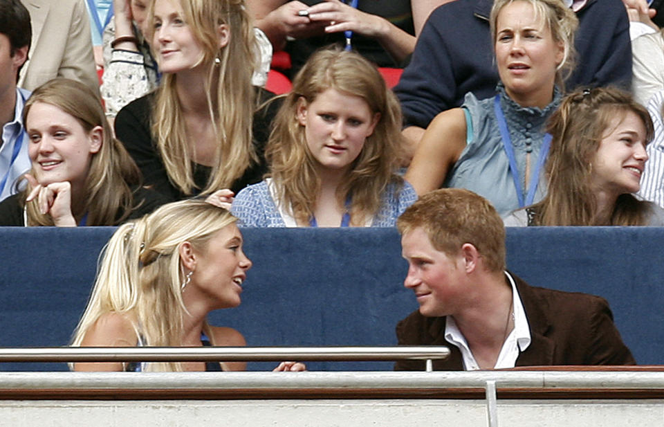 FILE - In this Sunday, July 1, 2007 file photo, Britain's Prince Harry, right, talks to his girlfriend Chelsey Davy at the Concert for Diana at Wembley Stadium in London. Princess Diana’s little boy, the devil-may-care red-haired prince with the charming smile is about to become a father. The arrival of the first child for Prince Harry and his wife Meghan will complete the transformation of Harry from troubled teen to family man, from source of concern to source of national pride. (Stephen Hird/Pool Photo via AP, File)