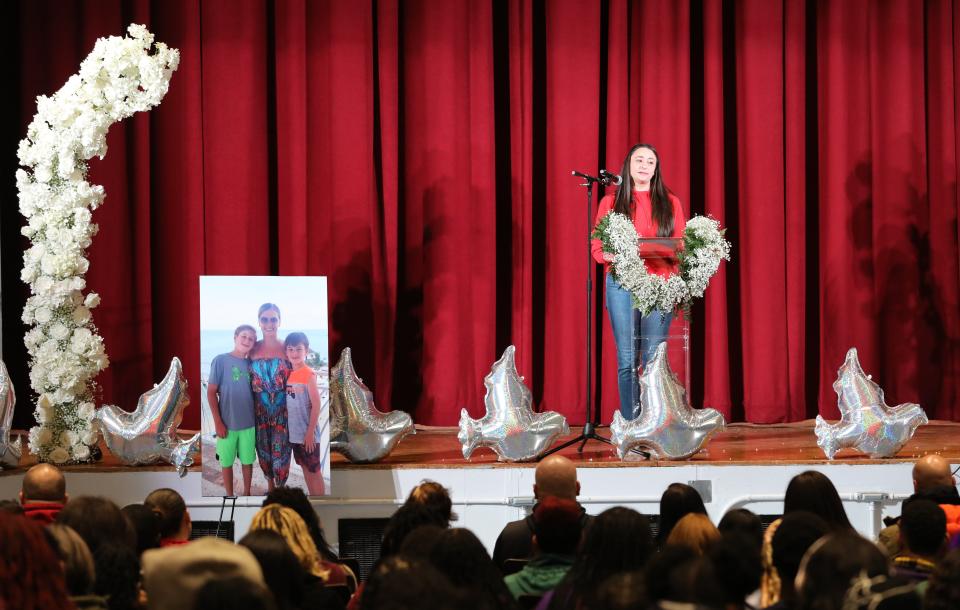 Sixth grade teacher Ms. Krug delivers heartfelt remarks during a memorial for teacher Ornela Morgan and her sons, Gabriel, 12 and Liam, 10, at the One World Middle School in the Bronx, Feb. 2, 2024.