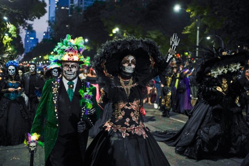Revellers celebrating Day of the Dead in Mexico City (AP)