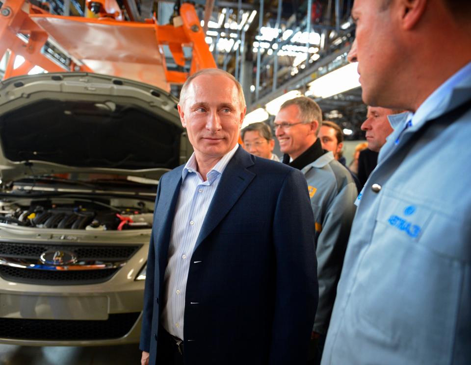 Russian Prime Minister Vladimir Putin, second right, inspects a production line while visiting the Avtovaz plant, Russia's biggest car maker.