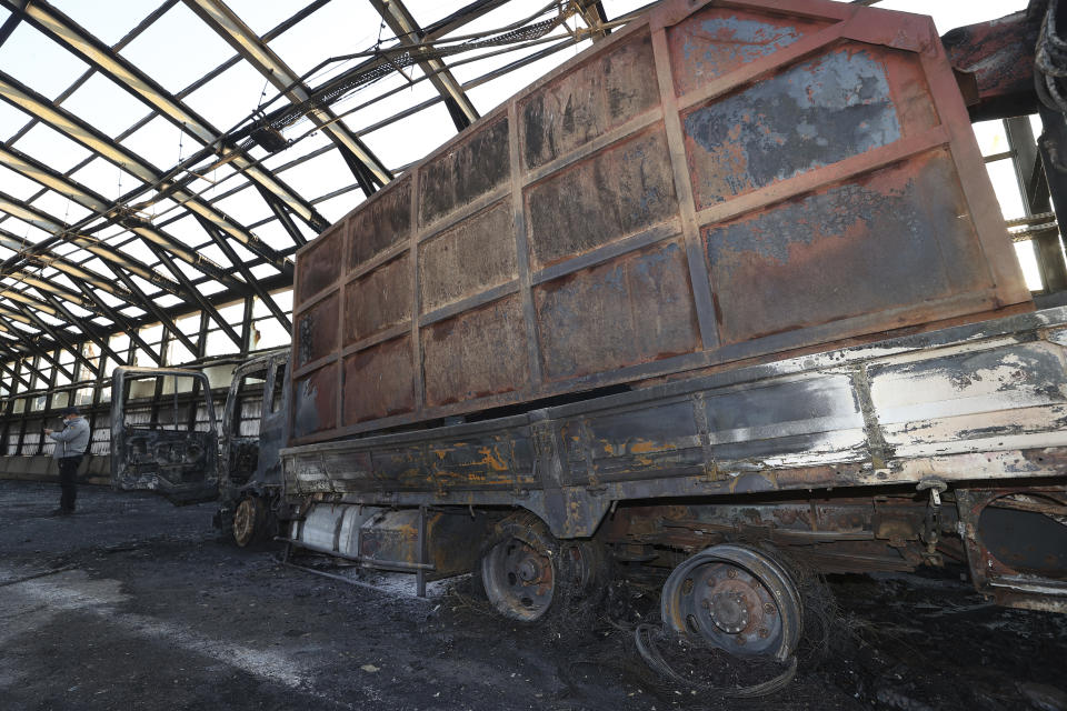 A burned out truck is seen at the scene in Gwacheon, South Korea, Thursday, Dec. 29, 2022. A freight truck collided with a bus on a highway near Seoul on Thursday, causing a fire that killed multiple people and injuring dozens of others, officials said. (Shin Hyun-woo/Yonhap via AP)