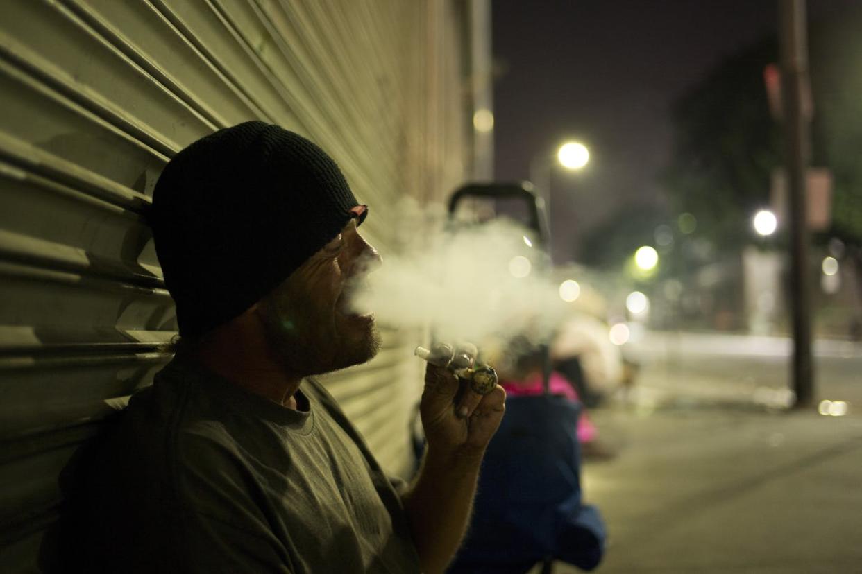 <span class="caption">A drug addict smoking crystal meth on Skid Row in downtown Los Angeles.</span> <span class="attribution"><a class="link " href="http://www.apimages.com/metadata/Index/APTOPIX-Homeless-Crisis-on-the-Coast-Photo-Gallery/854421aedac84655854ae18e015b0021/62/0" rel="nofollow noopener" target="_blank" data-ylk="slk:AP photo/Jae C. Hong;elm:context_link;itc:0;sec:content-canvas">AP photo/Jae C. Hong</a></span>