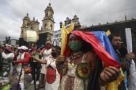 Protesters gather in Plaza Bolivar to demonstrate against the government’s handling of a wide range of issues including the economic fallout of the pandemic and implementation of the peace accord, as part of a national strike in Bogota, Colombia, Wednesday, Oct. 21, 2020. Indigenous leaders, students and union members gathered at in the historic square waving flags and banners decrying the government nearly one year after massive protests rocked the country only to fizzle with little to show by way of reform. (AP Photo/Fernando Vergara)