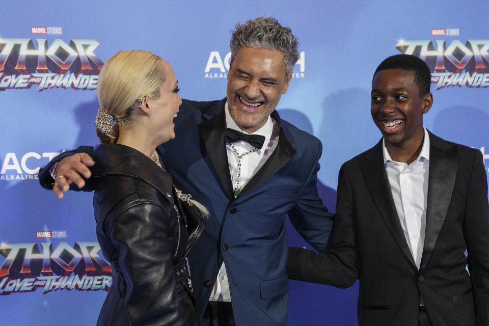 Pom Klementieff, from left, director Taika Waititi and Kieron L. Dyer pose for photographers upon arrival at the screening of the film 'Thor: Love and Thunder in London Tuesday, July 5, 2022. (AP Photo/Scott Garfitt)