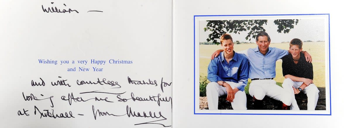 Prince Charles put his arms around his sons in this photo on the front of his 1999 Christmas card (PA)