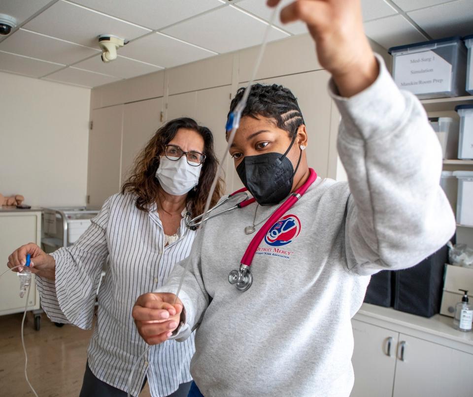 University of Detroit-Mercy nursing student Sequoia Mitchell, 26, right, and clinical nursing instructor Barb Ciotta, 59, left, work on setting up an IV in the Health Sciences building at the University of Detroit-Mercy in Detroit on Monday, March 14, 2022.