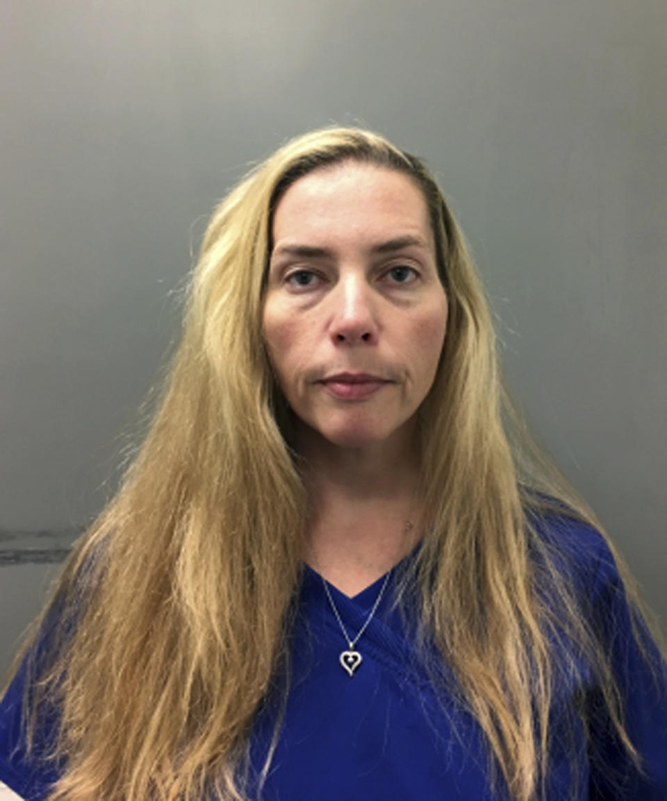 This undated photo released by the Bucks County (Pa.) District Attorney's Office shows Kelly Drucker in Pa. Prosecutors say Lawrence Weinstein, a former Pennsylvania township official, and his girlfriend, Drucker, spiked a woman’s drink and used a hidden camera to take sexually explicit photographs of her while she was unconscious. Weinstein and Drucker are charged with false imprisonment, invasion of privacy, recklessly endangering another person, criminal conspiracy and violations of the Pennsylvania Wiretap Act. They surrendered to Bucks County detectives Tuesday, Oct. 9, 2018. (Bucks County District Attorney's Office via AP)