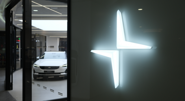 Close up Polestar logo with electric car in store. Polestar (PSNY) is a Swedish automotive brand owned by Volvo Cars and Geely