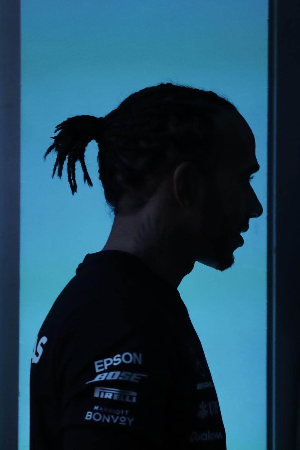 Mercedes driver Lewis Hamilton, of Britain, is silhouetted against a blue background during a news conference in Sao Paulo, Brazil, Wednesday, Nov. 13, 2019. Brazil's Formula 1 GP will take place on Sunday. (AP Photo/Nelson Antoine)