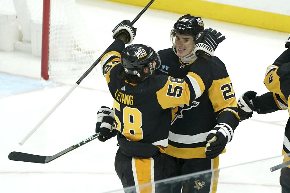 Pittsburgh Penguins' Ryan Graves is congratulated by Kris Letang for a goal against the Vegas Golden Knights during the first period of an NHL hockey game, Sunday, Nov. 19, 2023, in Pittsburgh. (AP Photo/Matt Freed)