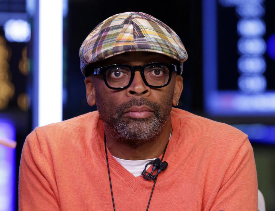 FILE - In this July 31, 2013, file photo, filmmaker Spike Lee is interviewed on the floor of the New York Stock Exchange. Pepsi is pairing singers and filmmakers to release a visual album that celebrates soccer during World Cup. Spike Lee, Timbaland, Idris Elba and Kelly Rowland are some of the artists whose work is featured on the Pepsi-curated album, "Beats of the Beautiful Game," to be released June 10, 2014. The soda company announced Monday, May 12 its album will be a collection of 11 anthem-like songs and short films. (AP Photo/Richard Drew, File)