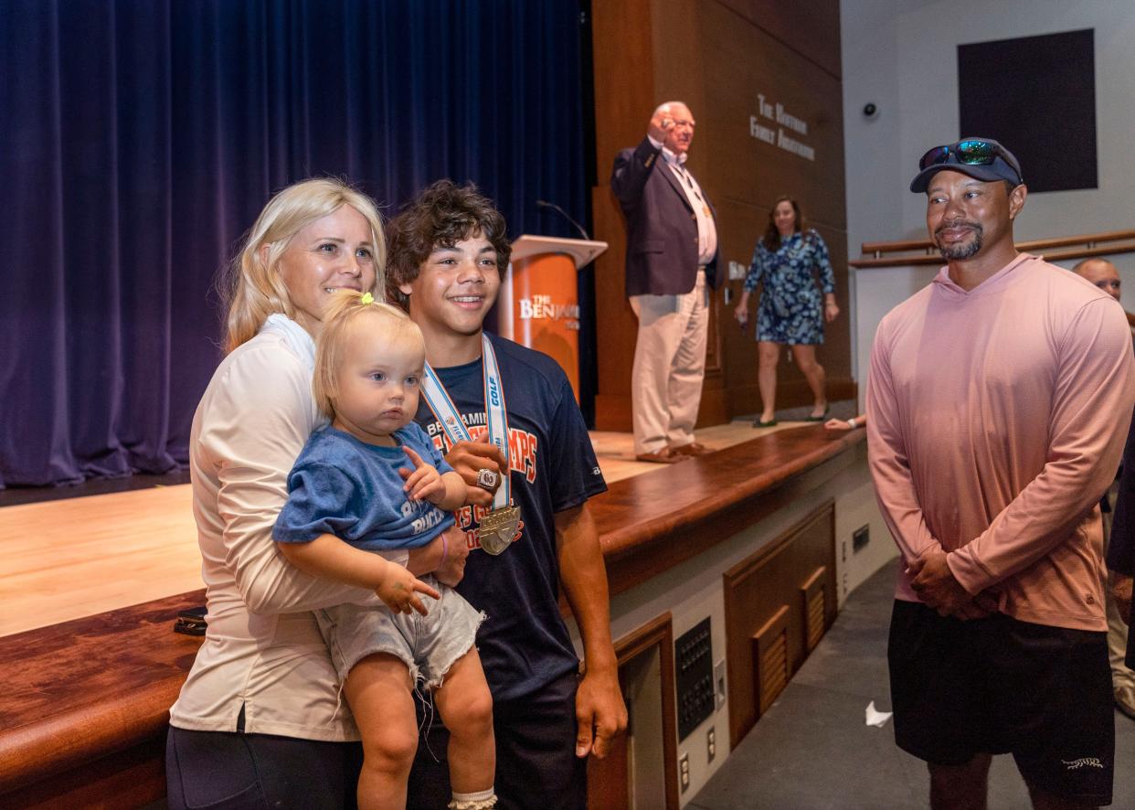 Elin Nordegren, left, poses for a picture with her son, Charlie Woods, to her right, as his father, Tiger Woods smiles during a ceremony to celebrate The Benjamin School boys golf team's 2023 state championship on March 26, 2024 in Palm Beach Gardens.