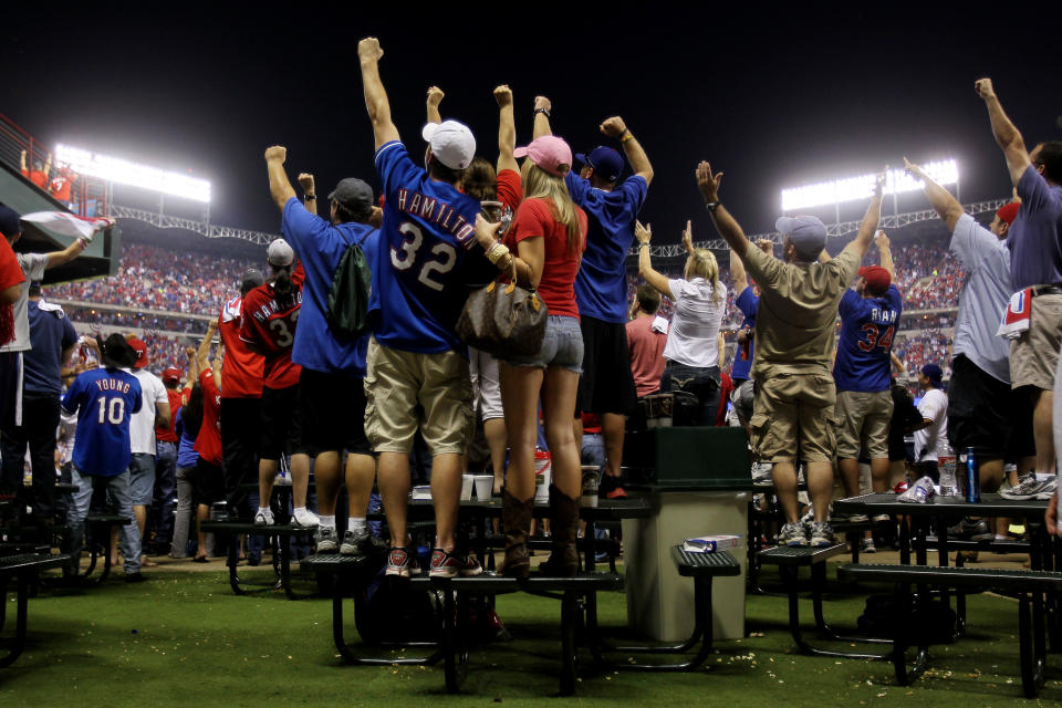 ARLINGTON, TX - OCTOBER 24: Fans cheer after a home run by Mitch Moreland #18 of the Texas Rangers in the third inning during Game Five of the MLB World Series against the St. Louis Cardinals at Rangers Ballpark in Arlington on October 24, 2011 in Arlington, Texas. (Photo by Ezra Shaw/Getty Images)