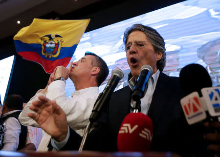 Ecuadorean presidential candidate Guillermo Lasso speaks near vice president candidate Andres Paez while waiting for the results of the national election in a hotel in Guayaquil, April 2, 2017. REUTERS/Mariana Bazo