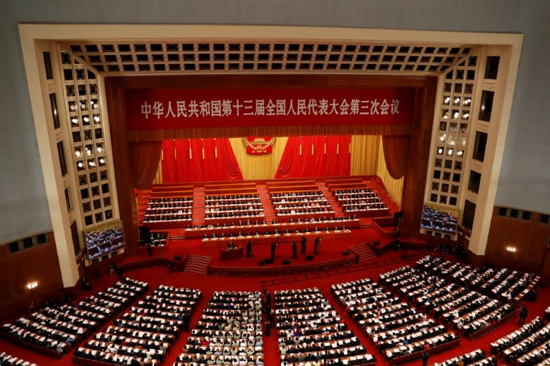 FILE PHOTO: Officials and delegates attend the opening session of NPC in Beijing