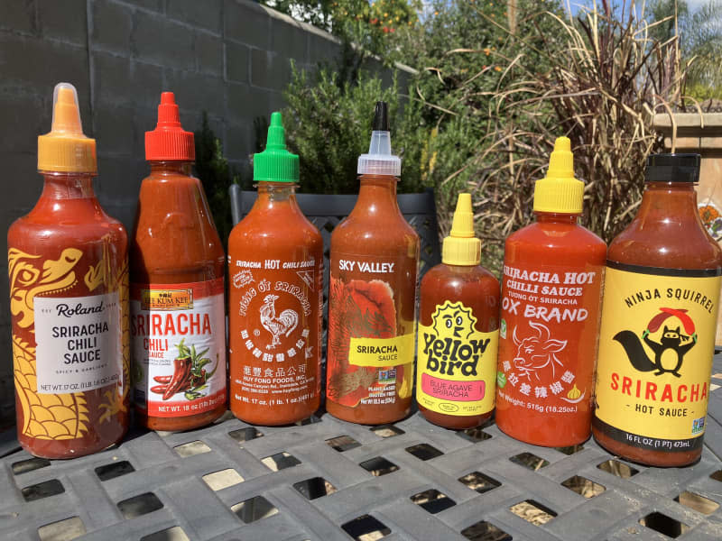 Group shot of Siracha bottles.