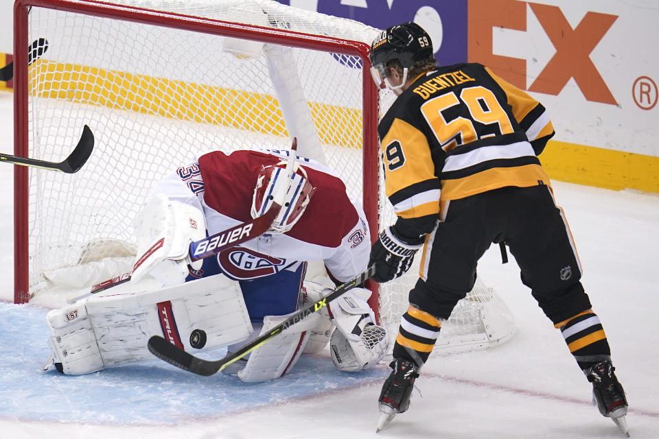 Montreal Canadiens goaltender Jake Allen (34) stops a shot by Pittsburgh Penguins' Jake Guentzel (59) during the first period of an NHL hockey game in Pittsburgh, Saturday, Nov. 27, 2021. (AP Photo/Gene J. Puskar)