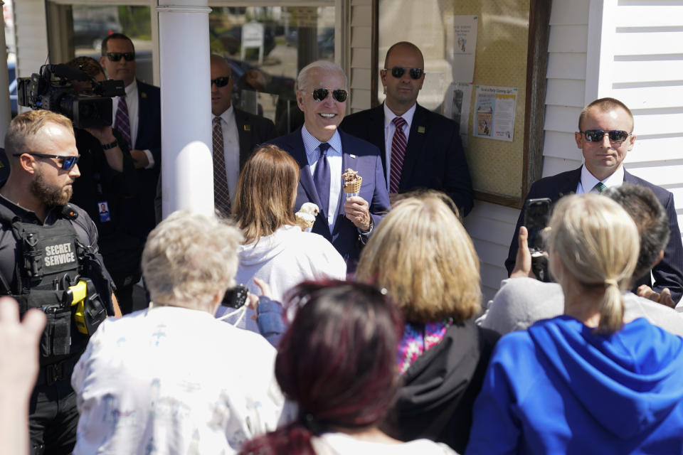 President Joe Biden talks with people as he holds an ice cream cone at Honey Hut Ice Cream, Thursday, May 27, 2021, in Cleveland. (AP Photo/Evan Vucci)