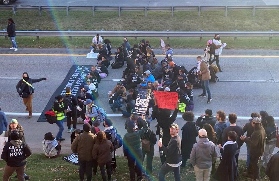 Protesters against the Israel-Gaza War block two lanes of the Durham Freeway stalling rush hour traffic Thursday afternoon, Nov. 2, 2023.