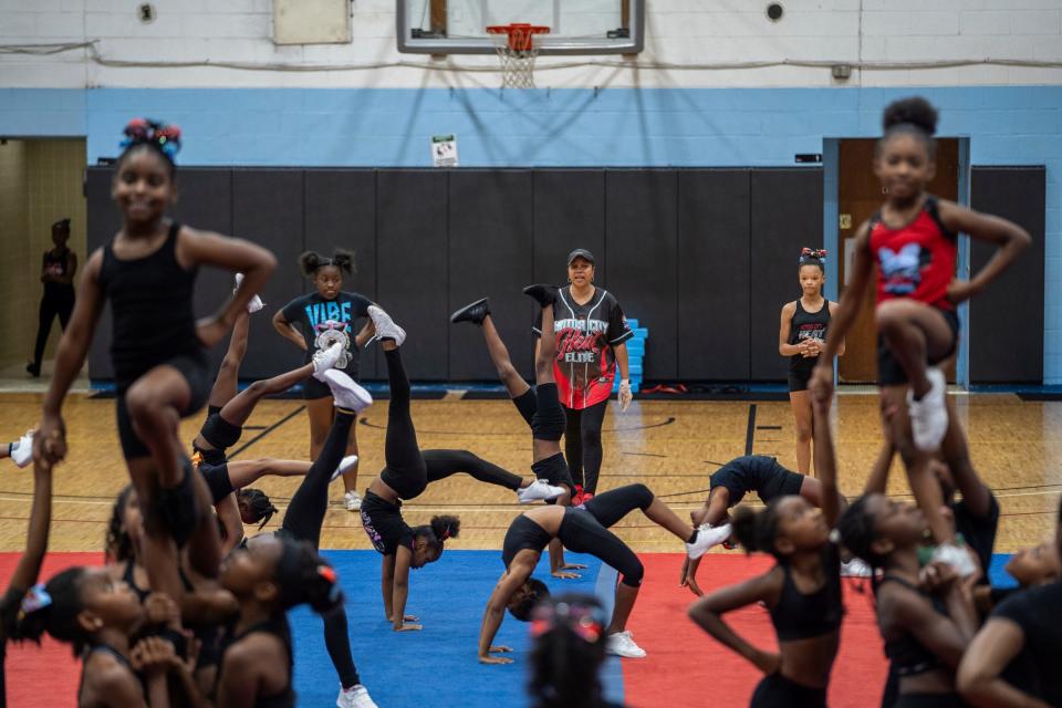 Detroit PAL cheer commissioner Glenda "Coach Pott" Stancil, center, watches as different divisions of the Motor City Heat Elite cheer team practice at St. Paul Tabernacle Church of God in Christ in Detroit on Aug. 22, 2023.