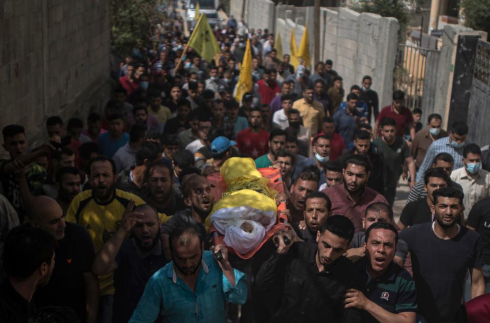 Palestinian mourners carry the body of 11-year-old Hussain Hamad (AP)