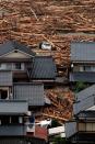 <p>In this aerial image, cars are washed away among driftwood as torrential rain hit on July 6, 2017 in Asakura, Fukuoka, Japan. (Photo: The Asahi Shimbun via Getty Images) </p>