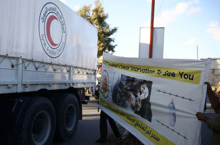 An aid convoy of Syrian Arab Red Crescent drives through the rebel-held city of Douma, in the eastern Damascus suburb of Ghouta, Syria October 30, 2017. REUTERS/Bassam Khabieh