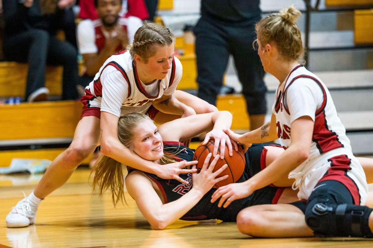 IUSB's Maddie Gard, left, and Katie Gard (11) fight for a loose ball with IU Northwest’s Michaela Schmidt for a loose ball during the IUSB vs. IU Northwest women’s CCAC Tournament Championship game Monday, Feb. 27, 2023 in the Student Activities Center on campus at IUSB in South Bend, Ind. (Photo by Michael Caterina/Indiana University South Bend)