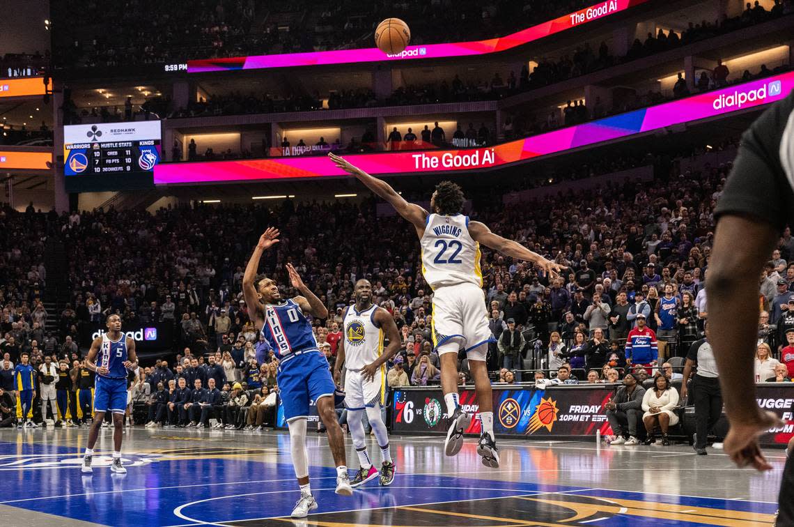 Sacramento Kings guard Malik Monk (0) lets the game winning shot against Golden State Warriors forward Andrew Wiggins (22) during an NBA in-season tournament game at Golden 1 Center on Tuesday, Nov. 28, 2023. Kings won 124-123 to advance in the in-season tournament. Hector Amezcua/hamezcua@sacbee.com