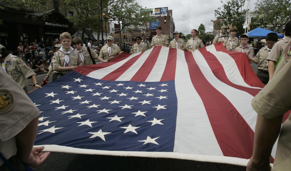 Boy Scout Troop 18 of Freehold carries a large American flag along Main Street in Freehold Borough during the town's 142nd Memorial Day Parade in 2016.