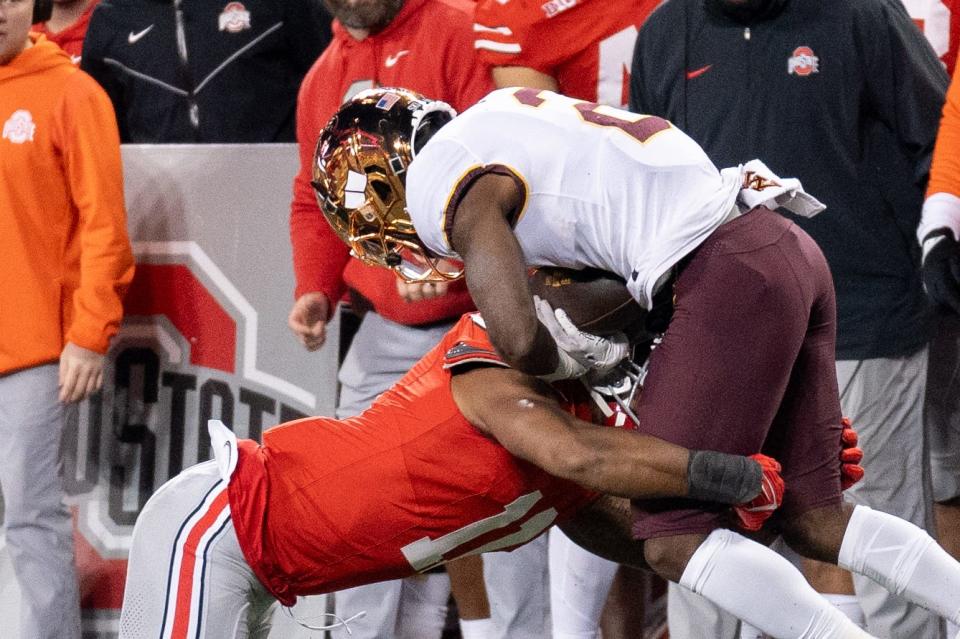 Nov 18, 2023; Columbus, Ohio, USA; 
Ohio State Buckeyes linebacker C.J. Hicks (11) tackles Minnesota Golden Gophers running back Sean Tyler (2) during the second half of their game on Saturday, Nov. 18, 2023 at Ohio Stadium.